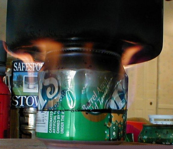stove lit with pot on top